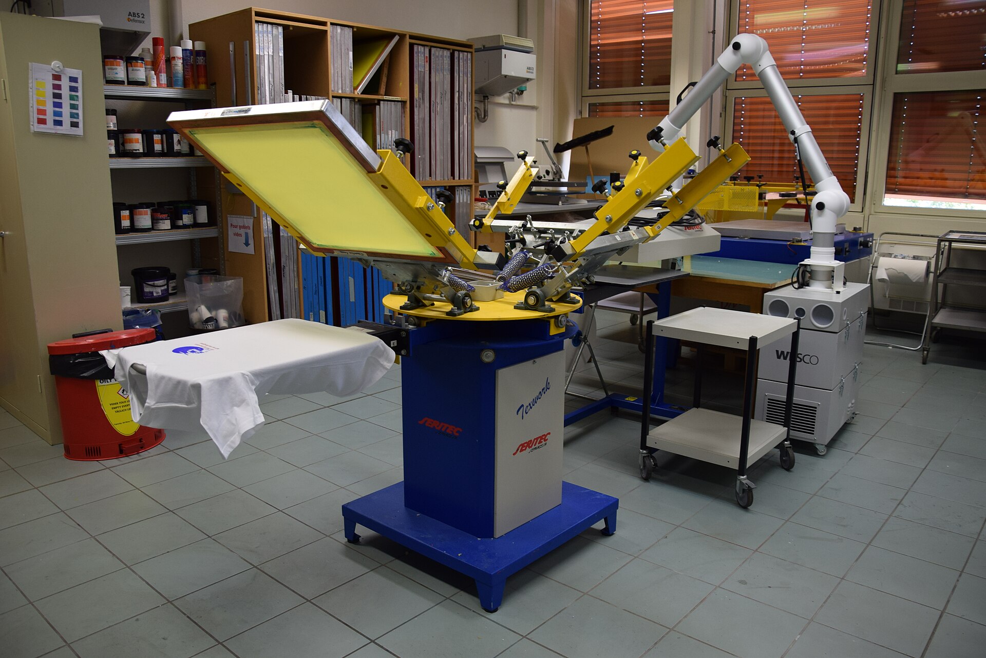 SK91 Concepts printing workshop with heat press and freshly printed branded apparel